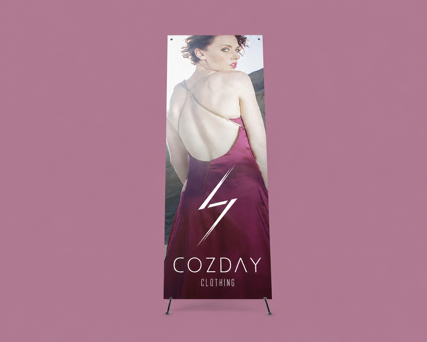 Cozday Clothing retail display on a solid dusty-mauve background